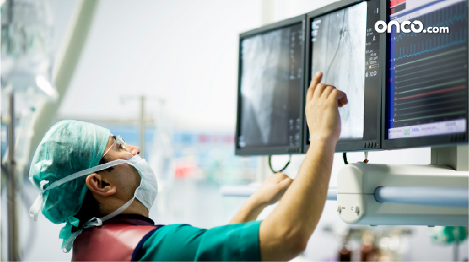 Photograph of surgeon monitoring screen for stage 2 throat cancer treatment