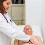 Picture of a doctor examining a patient for liver cancer
